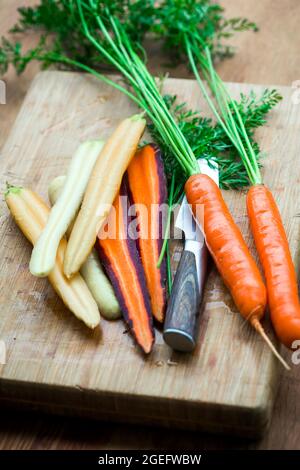Close up shots of three varieties of carrots on a cutting board Stock Photo