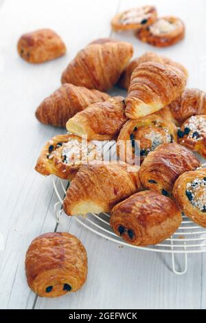 Pastries: “pain au chocolat” or chocolate croissant , croissants and pains aux raisins” or Chelsea bun Stock Photo