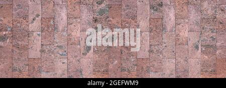 Wall cladding made of coarse, abstract textured, red brown stone tiles Stock Photo