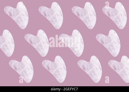 Pattern of pink jade guasha massagers or natural stone scrapers Stock Photo