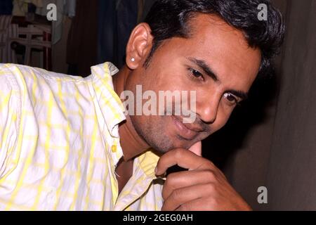 Indian man looking down in a happy pose. Stock Photo