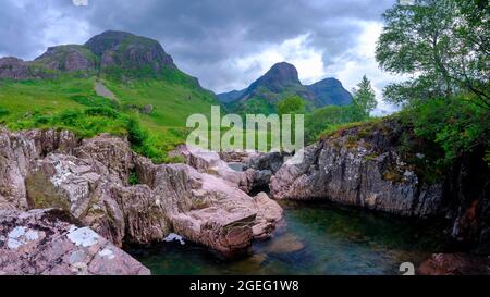 Glencoe, Scotland - August 5, 2021:  The Three Sisters of Glencoe with the waterfalls near the Study, Scotland Stock Photo