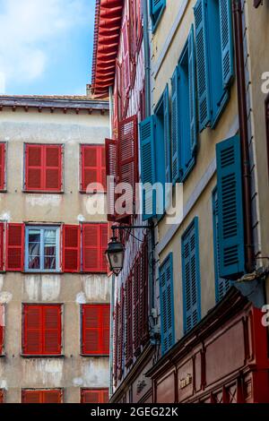 Bayonne (south western France): detail of typical building facades with colorful shutters, Basque buildings and houses in the town center Stock Photo
