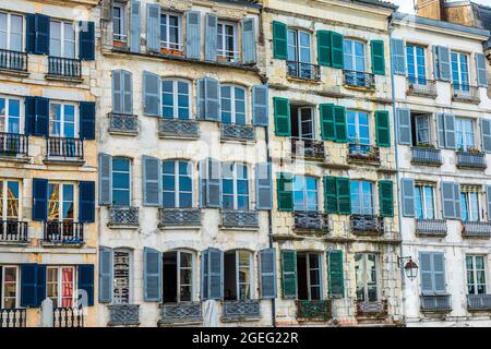 Bayonne (south western France): detail of typical building facades with colorful shutters, Basque buildings and houses in the town center Stock Photo