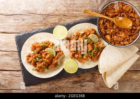 Chilorio Tacos tasty Mexican food closeup in the slate board on the table. Horizcontal top view above Stock Photo