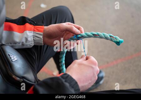 Technical college “Lycee Pierre Loti” in Paimpol (Brittany, north western France): mending of fishing nets and marlinespike seamanship, students in a Stock Photo