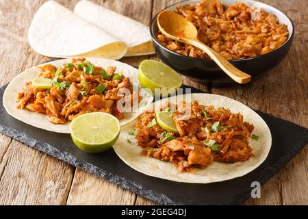 Mexican Shredded Pork Chilorio Tacos closeup in the slate board on the table. Horizcontal Stock Photo