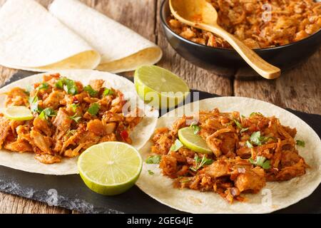 Slow Cooked Chilorio Sinaloan Chile Braised Pork served with tortilla closeup in the slate board on the table. Horizcontal Stock Photo