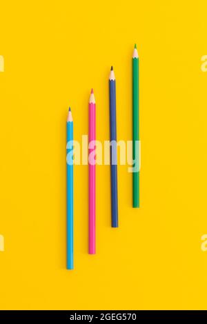 Colored pencils on yellow background. Top view with copy space. Flat lay. Back to school concept. Stock Photo