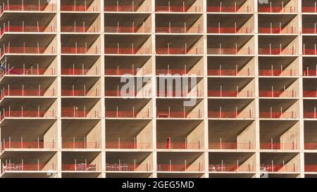 Repeating pattern of a residential skyscraper under construction in Canary Wharf, London Stock Photo