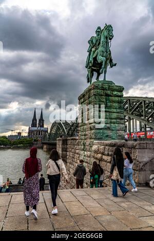 Cologne Cathedral, people on the Hohenzollern Bridge, equestrian statue of Kaiser Wilhelm I. Rhine promenade, Cologne, NRW, Germany, Stock Photo