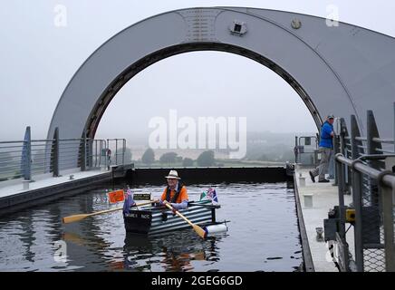 Michael Stanley, known as 'Major Mick', with his home-made boat 'Tintanic II' at the Falkirk Wheel with his boat on the rotating boat lift to raise money for Alzheimer's Research UK. The 80-year-old retired Army major plans to row 100 miles on rivers, canals and open water in the UK. Picture date: Friday August 20, 2021. Stock Photo