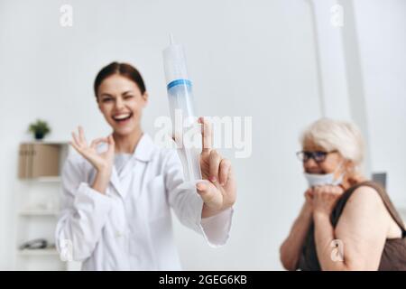 emotional elderly woman hand injection immunity protection Stock Photo