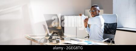 Arms Stretch Exercise Sitting At Desk In Office Stock Photo