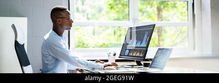 African Advisor Using KPI Dashboard With Financial Analytics Graphs Stock Photo