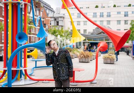 Artist Yuri Suzuki with his sculpture Sonic Bloom at Brown Hart Gardens in Mayfair, London. Picture date: Friday August 20, 2021. Stock Photo