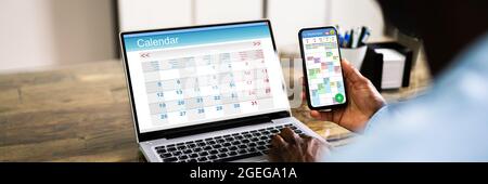 African American Doing Calendar Schedule Planning. Business Agenda In Office Stock Photo