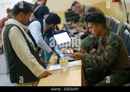 Kabul, Afghanistan. 18th Aug, 2021. A U.S. Marine assigned to 24th Marine Expeditionary Unit, processes Afghan civilians for evacuation at Hamid Karzai International Airport as part of Operation Allies Refuge August 18, 2021 in Kabul, Afghanistan. Credit: Planetpix/Alamy Live News Stock Photo