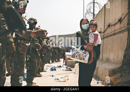 Kabul, Afghanistan. 18th Aug, 2021. U.S. Marines assigned to 24th Marine Expeditionary Unit, escort a civilian for evacuation at Hamid Karzai International Airport as part of Operation Allies Refuge August 18, 2021 in Kabul, Afghanistan. Credit: Planetpix/Alamy Live News Stock Photo