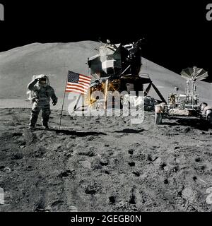 (1 Aug. 1971) --- Astronaut James B. Irwin, lunar module pilot, gives a military salute while standing beside the deployed United States flag during the Apollo 15 lunar surface extravehicular activity (EVA) at the Hadley-Apennine landing site. The flag was deployed toward the end of EVA-2. The Lunar Module (LM) 'Falcon' is in the center. On the right is the Lunar Roving Vehicle (LRV). This view is looking almost due south. Hadley Delta in the background rises approximately 4,000 meters (about 13,124 feet) above the plain. The base of the mountain is approximately 5 kilometers (about 3 statute Stock Photo