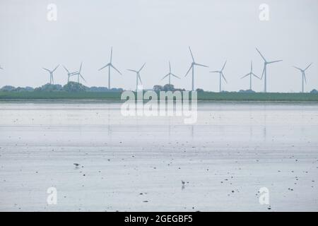 Wind turbines at the North Sea shore in Germany Stock Photo