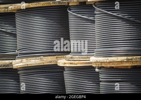 A high-voltage cables on spools used for electric power transmission Stock Photo