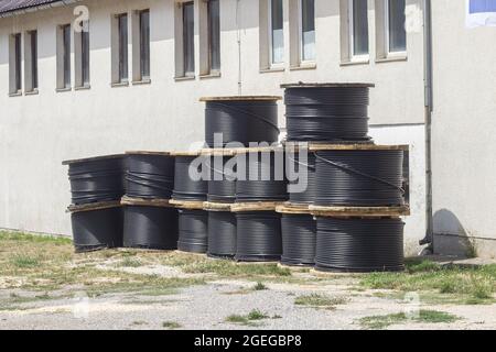 A high-voltage cables on spools used for electric power transmission Stock Photo