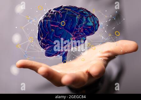 Male's hand holding an illustrated blue human brain Stock Photo
