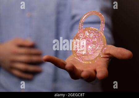 Male's hands holding an illustration of cybersecurity of digital network systems Stock Photo