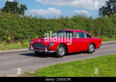 A front view of a 1960s 60s Red Aston Martin Db5 Coupe Petrol vintage classic car retro driver vehicle automobile Stock Photo