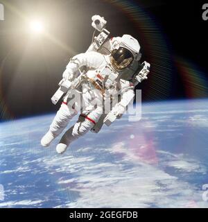 Astronaut in outer space on background of the Earth. Elements of this image furnished by NASA. Stock Photo