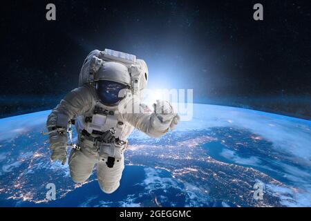 Astronaut in outer space on background of the Earth. Elements of this image furnished by NASA. Stock Photo