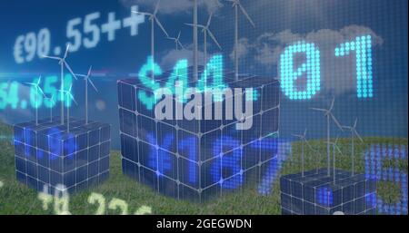 Stock market data processing against cubes of solar panels and windmills on grass against blue sky Stock Photo