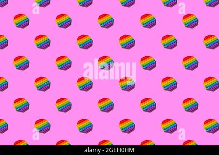 Anti-stress toy pop it on a pink background, pattern. Trend, background Stock Photo