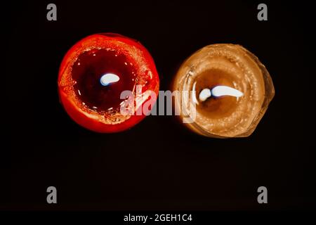 light candle burning brightly in the black background. Candle flame.Top view Stock Photo