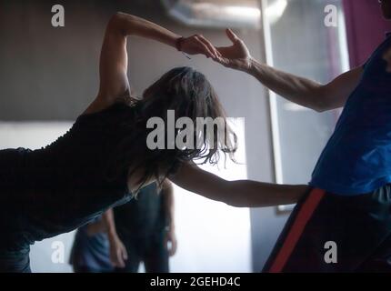 dancers hands in contact improvisation performance intentionally with motion blur ond defocus bokeh Stock Photo