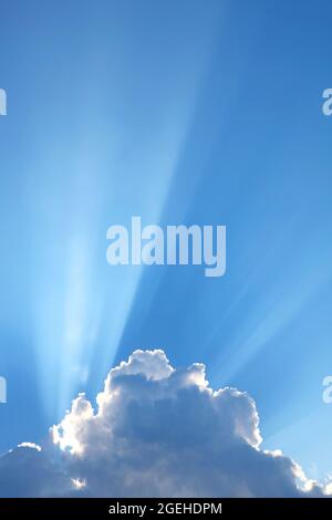 Incredible Sunbeam Shining Through the Fluffy Clouds Stock Photo