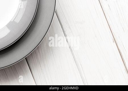 The modern classical porcelain set of plates stands on a white table Stock Photo