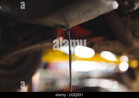 Close up of oil pouring out of car Stock Photo