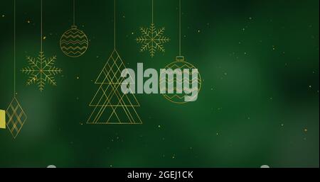 Digital image of golden confetti falling over christmas decorations hanging Stock Photo