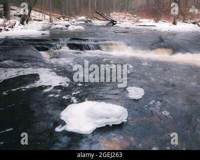 The Millers River in Royalston Massachusetts. This is a view of a river in Massachusetts in the winter. The river has cascades, snow and ice. Stock Photo