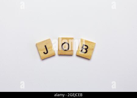 The inscription job made from wooden small cubes on a white background. Search robots, advertising, banner Stock Photo
