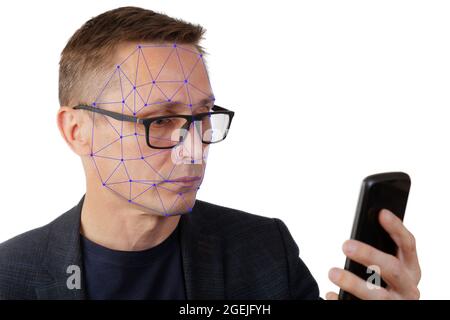 Portrait of man with smartphone using face ID recognition system. Isolared on white. Stock Photo