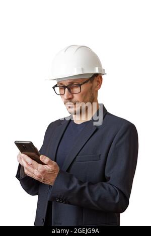 Engineer in a white construction helmet with smartphone in hand. Isolated on white. Stock Photo
