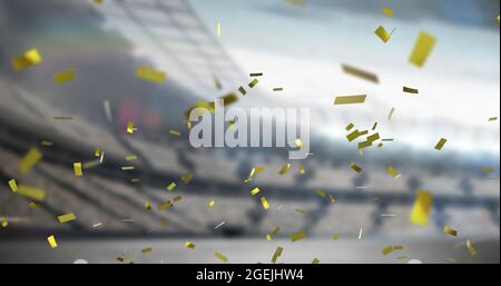 Image of golden confetti falling over empty sports stadium Stock Photo