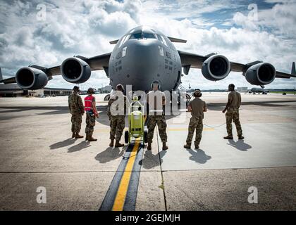 Airmen assigned to the 305th Maintenance Group prepare to launch a C-17 Globemaster III assigned to the 305th Air Mobility Wing at Joint Base McGuire-Dix-Lakehurst, N.J., Aug. 18, 2021. The 305th AMW is responsible for delivering Rapid Global Mobility to the U.S. and its allies throughout the world.  The unit’s C-17 fleet was relocated to support operations in Kabul, Afghanistan. (U.S. Air Force photo by Airman 1st Class Azaria E. Foster) Stock Photo