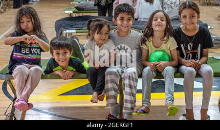 Al Udeied Air Base, Qatar. 20th Aug, 2021. Young children evacuated from Kabul wait at a shelter after arriving for processing August 20, 2021 at Al Udeied Air Base, Qatar. Credit: Planetpix/Alamy Live News Stock Photo