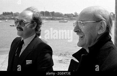 AJAXNETPHOTO. 1985. HAMBLE POINT, SOUTHAMPTON, ENGLAND. - FATHER & SON PHOTOGRAPHERS - FAMOUS COWES ISLE OF WIGHT MARINE PHOTOGRAPHERS (L-R) KENNETH AND KEITH BEKEN OF 'BEKEN OF COWES', ATTENDING THE OFFICIAL NAMING AND LAUNCH OF RICHARD BRANSON'S VIRGIN ATLANTIC CHALLENGER POWER CATAMARAN AT HAMBLE POINT.  PHOTO;JONATHAN EASTLAND/AJAX REF:1985 32A 9 Stock Photo