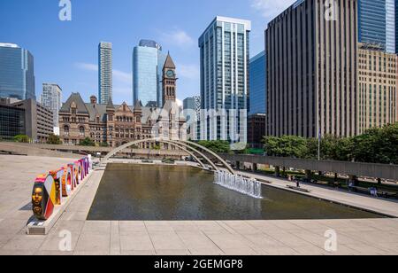 Toronto, Canada, August 10, 2021: Famous Toronto City Hall and Nathan Phillips Square fountain, a major tourist attraction and social hub for public events and festivals Stock Photo