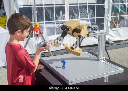Miami Florida,Homestead Speedway,DARPA Robotics Challenge Trials remote controlled,robot robots robotic arms boy male kid child, Stock Photo